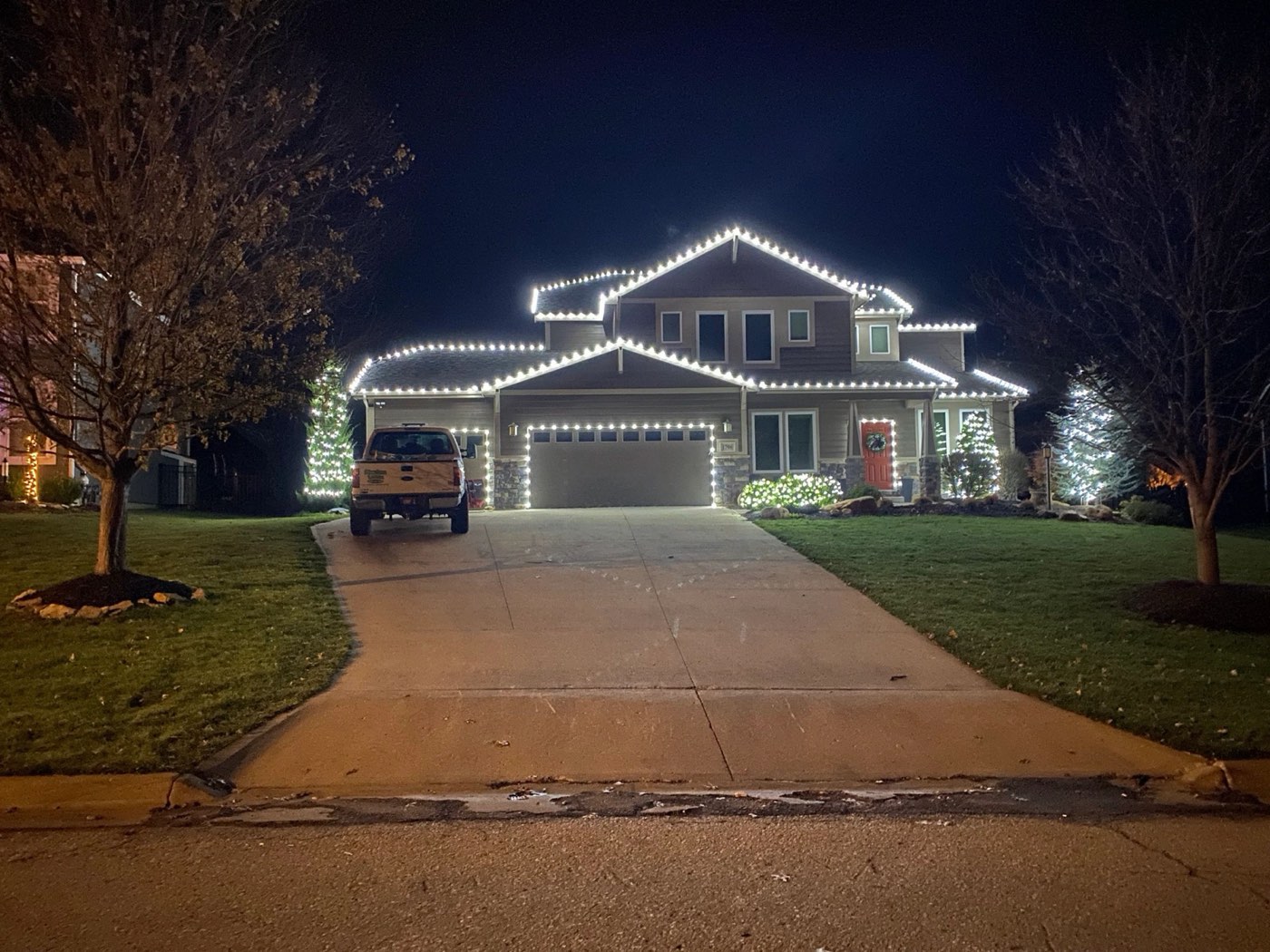 Home and driveway outlined in Christmas lights