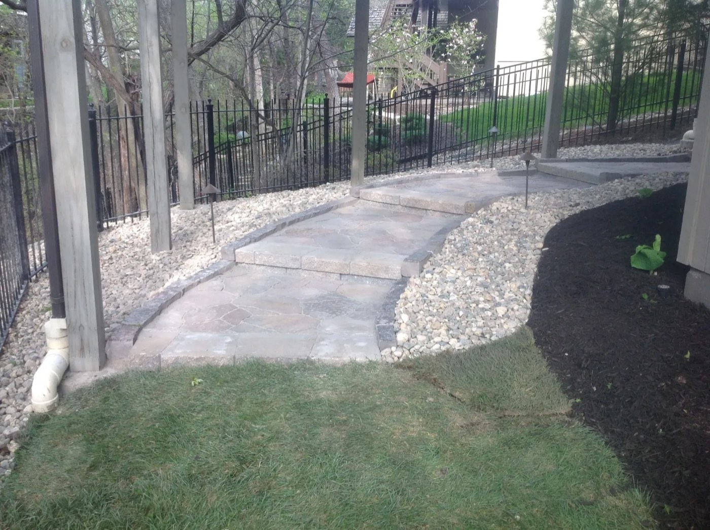 Flagstone walkway and steps with river rock beds and path lights